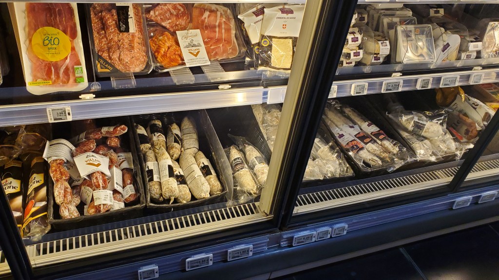 View of cured and dried meats and cheese at Monoprix